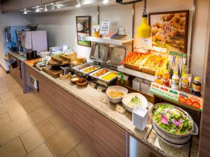a buffet line with many different types of food at Super Hotel Totsuka Eki Higashiguchi in Yokohama
