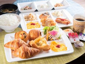 a plate of food with pastries and rice on a table at Super Hotel Totsuka Eki Higashiguchi in Yokohama