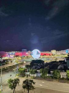 a large sign in a parking lot at night at Shell Residence Pasay City in Manila