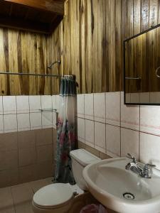 a bathroom with a toilet and a sink at Rincón Uruguayo in Monteverde Costa Rica +4 photos