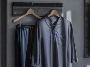 a coat and trousers hanging on a rack at Super Hotel Shinyokohama in Yokohama +91 photos