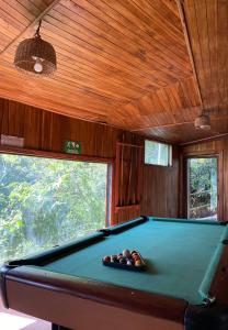 a billiard room with a pool table in a house at Rincón Uruguayo in Monteverde Costa Rica