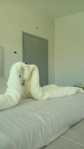 a white bed with a bunch of pillows on it at Karak Castle House in Kerak
