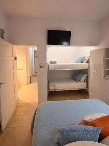 a bedroom with bunk beds with a flat screen tv at Dunas y Cielo in Tinogasta +11 photos