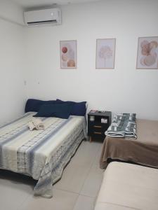 a bedroom with two beds in a room at COLOFT - Studio Térreo com Acessibilidade in Anápolis +11 photos