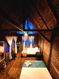 a room with two beds and a table in it at Nawala Eco-hostel in Termales - agua caliente - nuqui