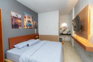 a bedroom with a bed and a television in it at Heyho Homestay Maluk in Maluk
