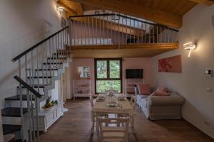 a living room with a staircase and a table at Il Moro in Tolentino