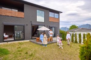a family standing in front of a house at Fuji Gran Villa - TOKI - in Fujiyoshida +44 photos