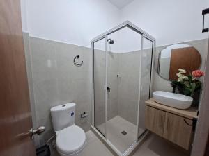 a bathroom with a shower and a toilet and a sink at Villa Kas Abao Doradal Ant in Doradal +24 photos