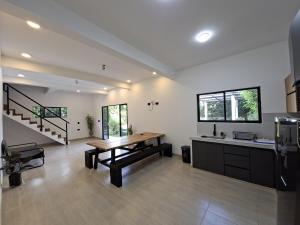 a living room with a wooden table and a staircase at Villa Kas Abao Doradal Ant in Doradal