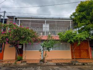 an old building with trees in front of it at Casa Liz in Managua