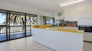 a kitchen with a counter and a large window at The Escape in Merimbula