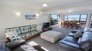 a living room with a couch and a table at The Escape in Merimbula