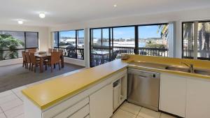 a kitchen with a view of a dining room at The Escape in Merimbula