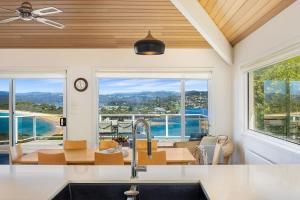 a kitchen with a sink and a large window at Bula Vista in Merimbula +15 photos