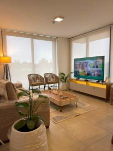 a living room with a couch and a tv at Feel Premiun 2401 in Asunción +10 photos