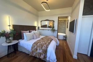 a bedroom with a large bed and a mirror at The Verdict in Martinborough