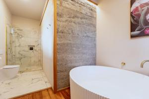a bathroom with a shower and a toilet and a sink at The Verdict in Martinborough