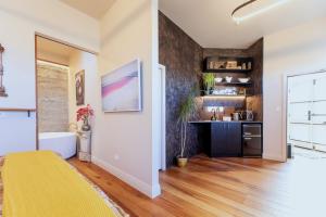 a bathroom with a tub and a sink in a room at The Verdict in Martinborough +6 photos