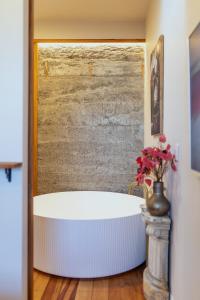 a bath tub in a room with a wall at The Verdict in Martinborough
