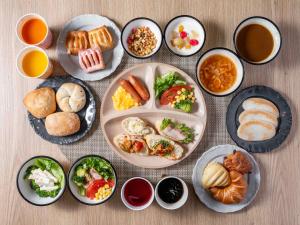 a table topped with plates of food with different foods at Super Hotel Shinagawa Shinbanba in Tokyo