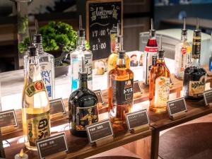 a display of bottles of alcohol on a table at Super Hotel Shinagawa Shinbanba in Tokyo