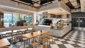 a restaurant with tables and chairs and a counter at The 27 Wynwood in Miami
