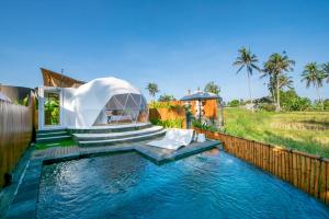 a water slide in the backyard of a house at Triyana Resort and Glamping Carangsari Bali in Payangan