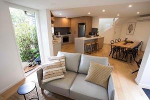 a living room with a couch and a kitchen at Monrepos in Point Lonsdale