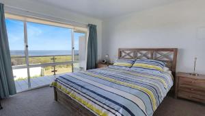 a bedroom with a bed with a view of the ocean at Quarterdeck 3 in Tura Beach +17 photos