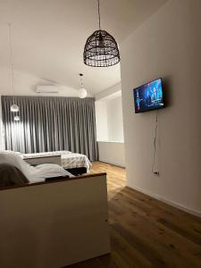 a bedroom with a bed and a tv on the wall at La Vicenta in Jesús María