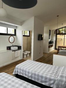 a bedroom with a bed and a bathroom with a sink at La Vicenta in Jesús María