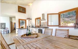 a kitchen and dining room with a wooden table at Sa Talaia in Lluc