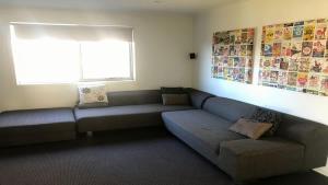 a living room with a couch and a window at Turaroo in Tura Beach