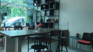 a bar in a restaurant with chairs and a table at Sleep cafe hidee247 in Pratunam +29 photos