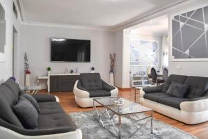 a living room with two couches and a tv at Sunset Marbella in Marbella
