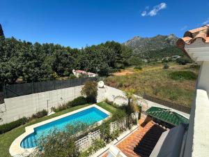 a swimming pool on the side of a house at Sunset Marbella in Marbella