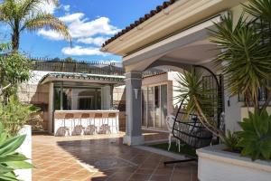a house with a patio with stools on the porch at Sunset Marbella in Marbella