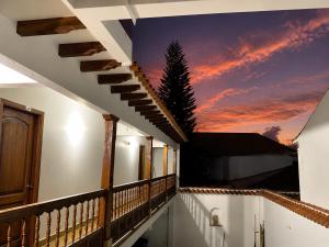 a balcony with a sunset mural on the wall at Yeshca Hotel Boutique in Villa de Leyva