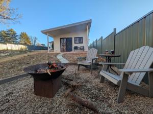 two chairs and a fire pit in a backyard at Elm's Deep Guest House in Berridale