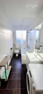 a white bathroom with a sink and a toilet at Moderne liebevolle Ferienwohnung in Bergkamen