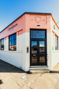 a store front with a black door on a street at The Advocate in Martinborough