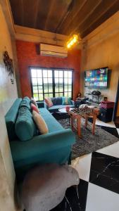 a living room with a blue couch and a table at Honeymoon Moonlight Khaoyai in Ban Tha Wua Tai