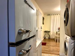 a kitchen with a stainless steel refrigerator and a dining room at Barker house-Sweet home in Niagara-on-the-Lake +15 photos