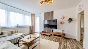 a living room with a couch and a flat screen tv at Moderne liebevolle Ferienwohnung in Bergkamen
