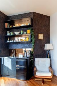 a kitchen with a sink and a chair in a room at The Advocate in Martinborough