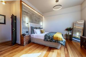 a bedroom with a large bed and wooden floors at The Advocate in Martinborough
