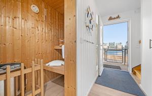 a room with wooden walls and a desk with a window at Seebär in Olpenitz