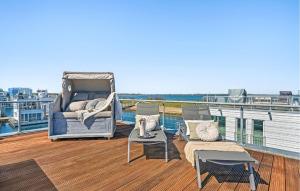 a balcony with chairs and a bed on a yacht at Seebär in Olpenitz +14 photos